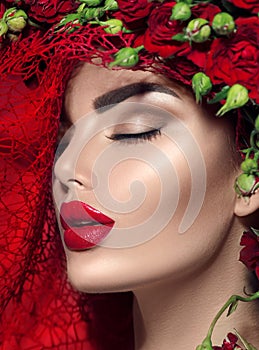 Model girl with red roses flower wreath and fashion makeup. Flowers hairstyle