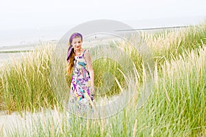 Model girl walking in sand dunes beach