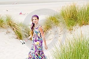 Model girl walking in sand dunes beach