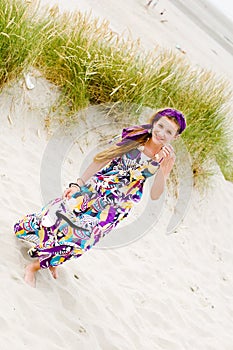 Model girl walking in sand dunes beach