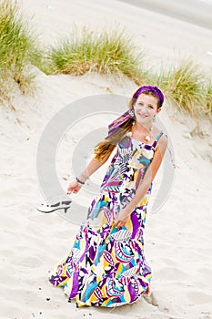 Model girl walking in sand dunes beach