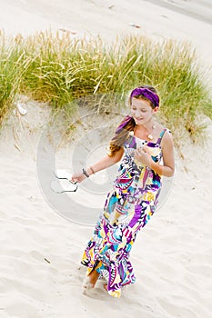 Model girl walking in sand dunes beach