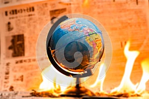 Model globe on fire. Planet Earth Burning. Global Warming and Climate Change Concept