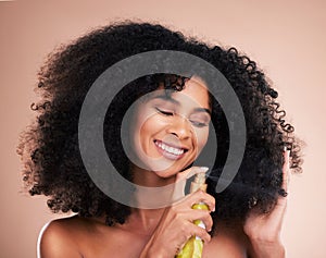 Model, happy or afro hair spray on isolated studio background in frizz control, curly management or oil treatment. Black