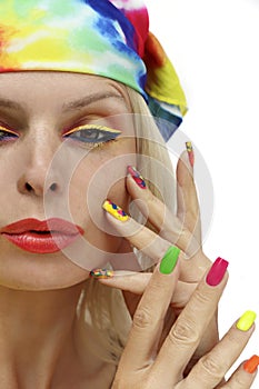 A model in a headscarf with a multicolored manicure