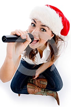 Model holding karaoke and wearing christmas hat