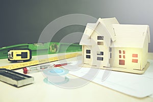 Model house on a construction plan for house building