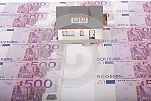 Model house and five hundred euro banknote