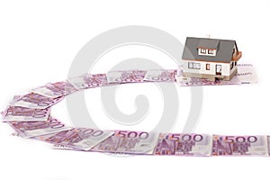 Model house and five hundred euro banknote road
