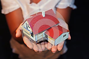 Model of house with garage on hands