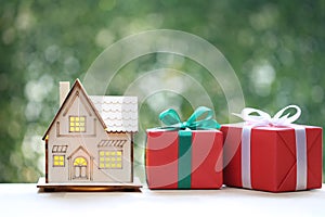 Model house and gift box with ribbon for Christmas and New Year\'s Day or Greeting season
