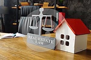 Model of house and real estate law plate.