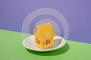 Model house served on a plate over a duo-tone background