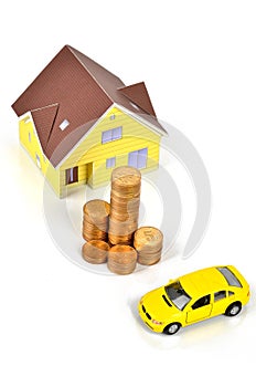 Model house and toy car with coins