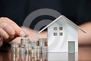 Model houses and stacked coins. Home equity loans. Mortgages and loans photo