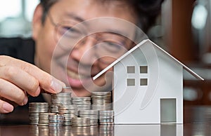 Model houses and stacked coins. Home equity loans. Mortgages and loans