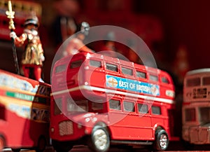 Model of iconic vintage red double decker London bus with slogan \'Best of British\' on the side.