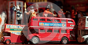 Model of iconic vintage red double decker London bus with slogan 'Best of British' on the side.
