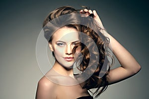 Model with long hair. Waves Curls Hairstyle. Hair Salon. Updo. F photo