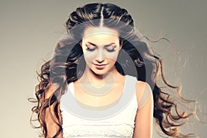 Model with long hair. Waves Curls Hairstyle. Hair Salon. Updo. F photo