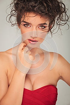 Model with messy hair posing and touching her face