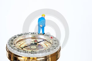Model miniature on compass on white