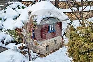 Model of a mountain house and mill covered with snow