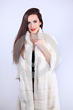 Model in natural fur coat looking at camera