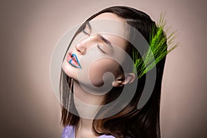 Model with natural makeup and blue lines on lips having spikelet in hair