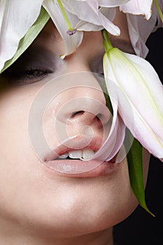 Model nipping flower's petal photo