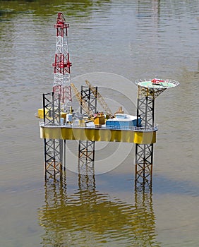 Model of oil rig platform standing on water