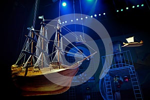 Model of an old wooden sailing ship with white sails