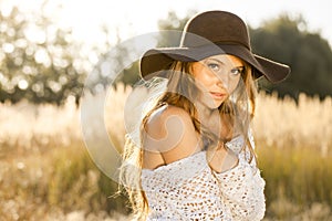 Model in open field at sunrise