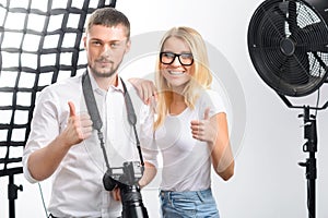 Model and photographer are smiling while showing