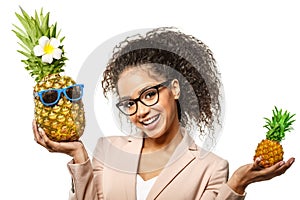 Model with pineapple in hands. African American Girl with Exotic Fruit. Cheerful woman with a smile relaxing on vacation. Image