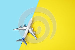 Model plane airplane or plane on yellow and blue background.