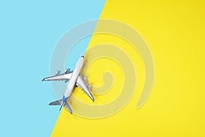 Model plane, airplane on yellow and blue background.