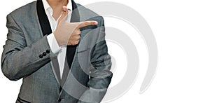 Model Pointing with finger on the right side of his shoulder wearing gray suit on white isolated backdrop