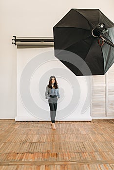 Model poses in photo studio, white background