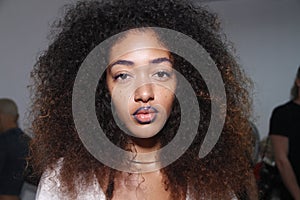 A model posing backstage before the PH5 Presentation