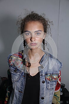 A model posing backstage before the PH5 Presentation