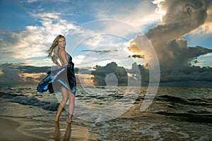 Model posing in beach dress at early morning sunrise