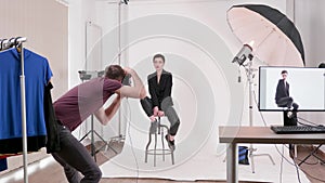 Model posing in fashion style to a professional photographer
