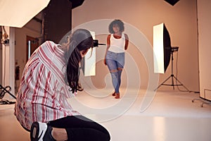 Model Posing For Female Photographer In Studio Portrait Session