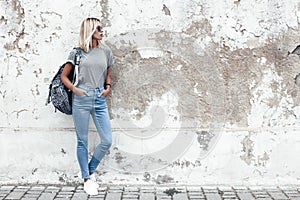 Model posing in plain tshirt against street wall
