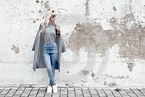 Model posing in plain tshirt against street wall