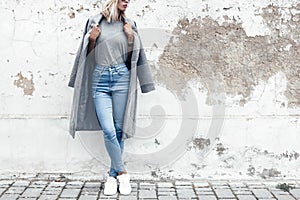 Model posing in plain tshirt against street wall