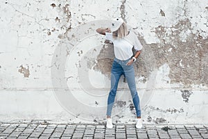 Model posing in plain tshirt against street wall