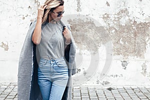 Model posing in plain tshirt against street wall