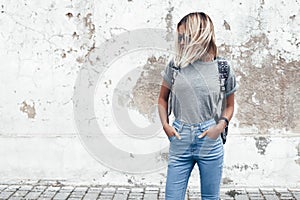 Model posing in plain tshirt against street wall